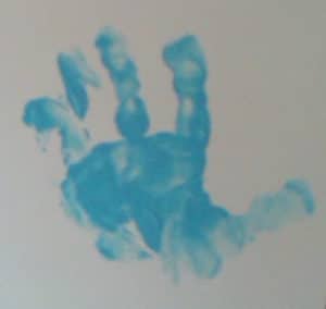 Child\'s handprint in blue paint