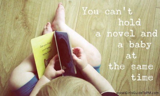 Toddler reading a board book