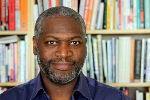 Bryan Barrow in front of a bookshelf