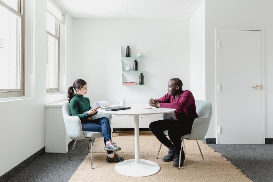 Two people sitting around a table doing an interview