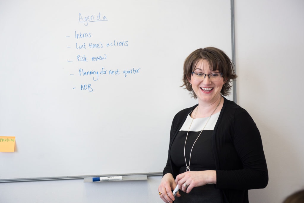 Elizabeth Harrin standing in front of a white board