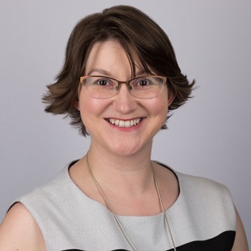 Elizabeth Harrin wearing glasses and smiling at the camera