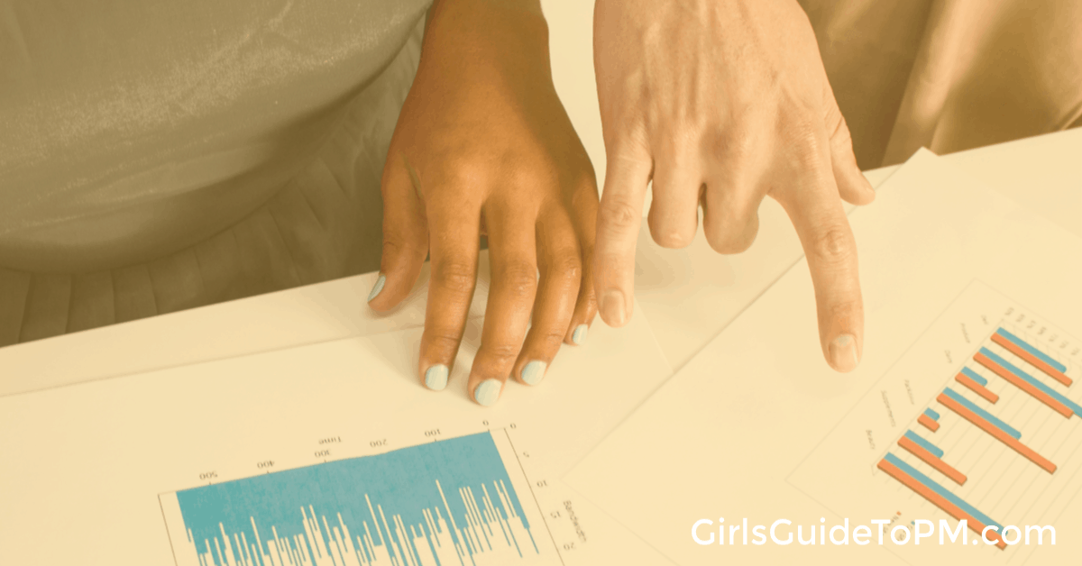 hands pointing at printed graphs