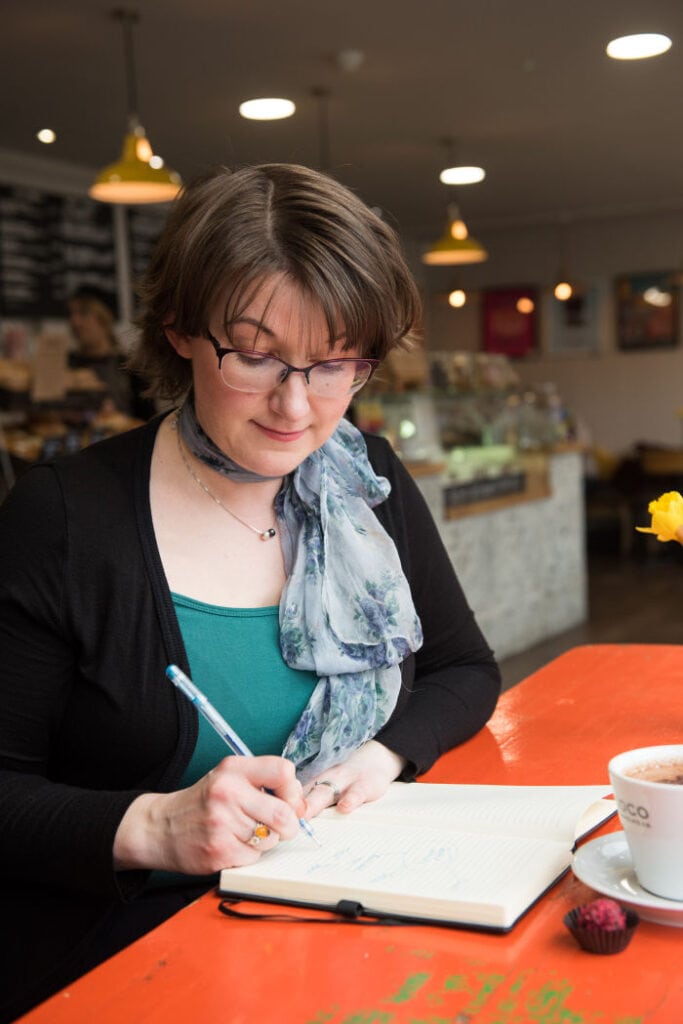 Elizabeth writing at desk