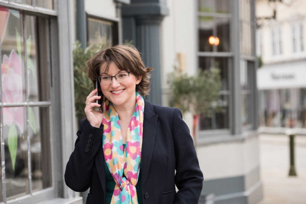 Elizabeth Harrin standing in front of a building talking on a cell phone