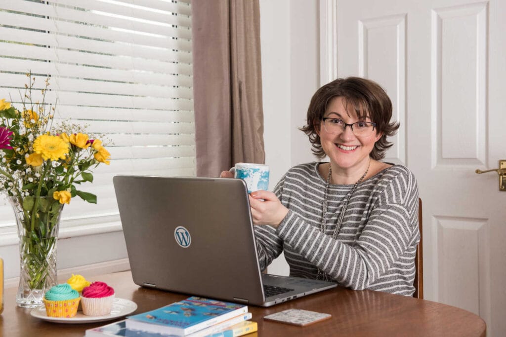 Elizabeth at desk with tea