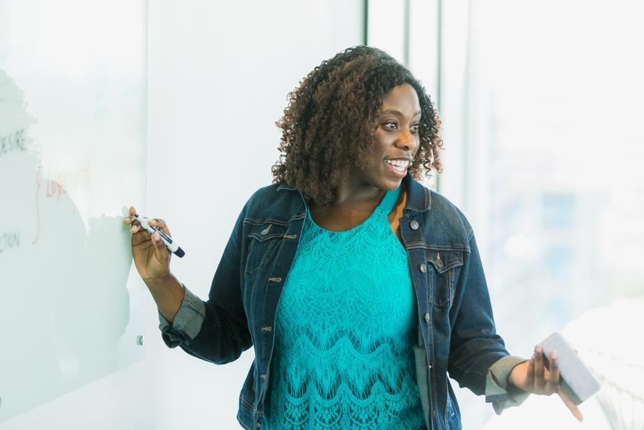 person presenting something at whiteboard