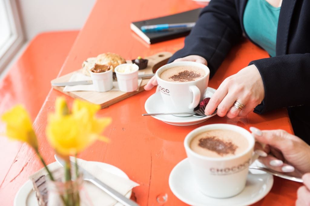 Elizabeth in cafe drinking a hot chocolate
