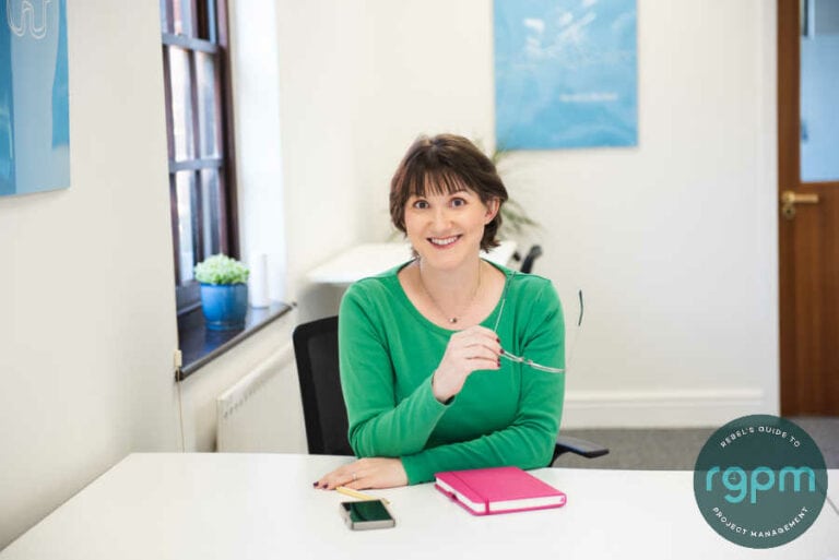 Elizabeth Harrin at a desk wearing a green top