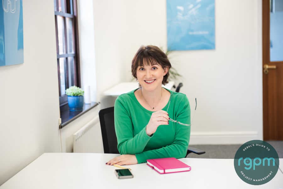 Elizabeth Harrin at a desk wearing a green top