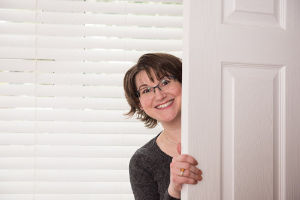 Elizabeth peeking out from behind a door