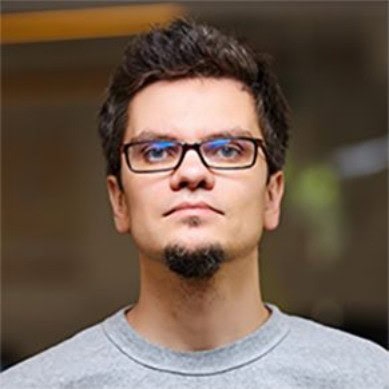 Oleksii (Alex) Kratko wearing glasses and a grey T shirt